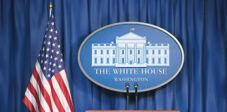 White House press briefing podium and US flag