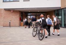 Students in uniforms arriving at a school entrance
