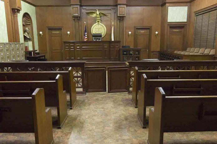 Interior view of an empty courtroom with wooden benches and a judges bench