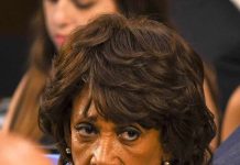 older woman with short wavy hair looking intently to the side