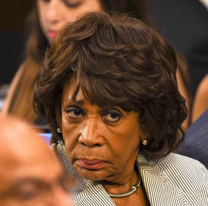 older woman with short wavy hair looking intently to the side