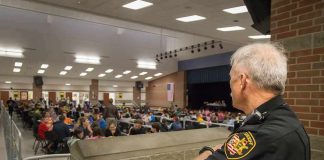 security officer overseeing a crowded school cafeteria