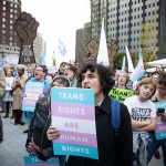 Dem Senator Viciously Mocked at Gay Pride Parade Crowd of protesters holding trans rights signs at a city rally