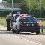 Amber Alert Shocker – Dad Flees to Mexico With Kids! Police officer conducting a traffic stop on a highway
