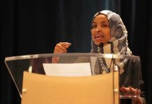 Ilhan Omar speaking at a podium with a microphone