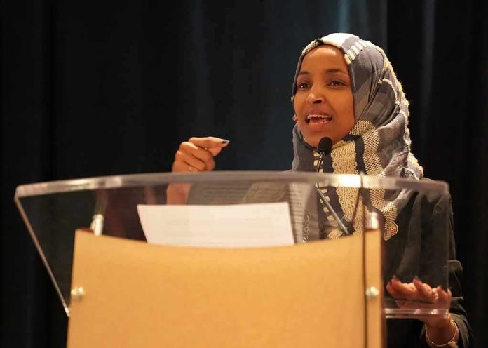 shutterstock_1282205566 Ilhan Omar speaking at a podium with a microphone