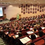 Now Dems Call Fitness as Fascist Large lecture hall filled with students during a presentation