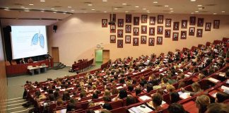Large lecture hall filled with students during a presentation