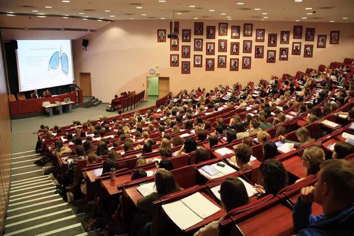 Large lecture hall filled with students during a presentation
