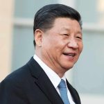 Trump Has Xi In STITCHES Over Biden Pic man in suit smiling outdoors