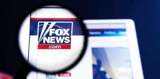 Fox News Producer Found Dead At Home Magnifying glass over Fox News website logo on a tablet