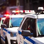police cars with flashing lights on a city street