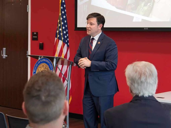 Speaker in a navy suit addressing an audience at a podium
