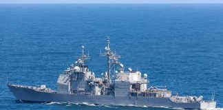 Gray naval warship cruising on open sea