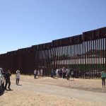 Senator STRUCK During Fiery Woke Protest! Border fence with group of people and a patrol vehicle