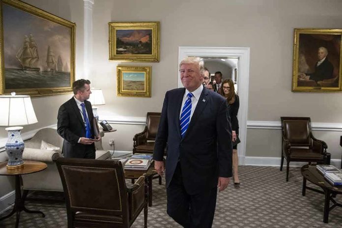 shutterstock_1456093772 Donald Trump walks through an office with Sean Lawler nearby and Mariano Rajoy following behind