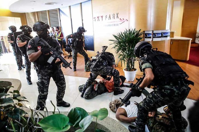 Tactical police detain suspects in an office lobby