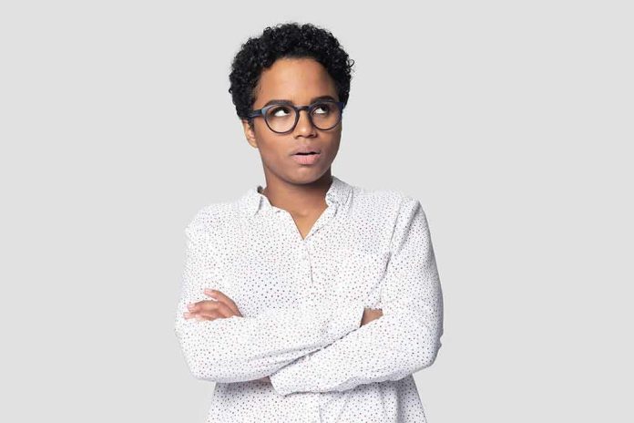 shutterstock_1541223119 Person with glasses crossing arms and looking up