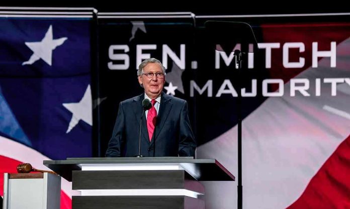 Man in suit speaking at a podium on a stage
