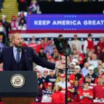 Trump Confirms GOP Convention — Two Shows In One Night Crowd at a political rally with a speaker at a podium; Stephen Paea, Curtis Lofton, Walter Jones, John Sullivan, and Colin David Jones present