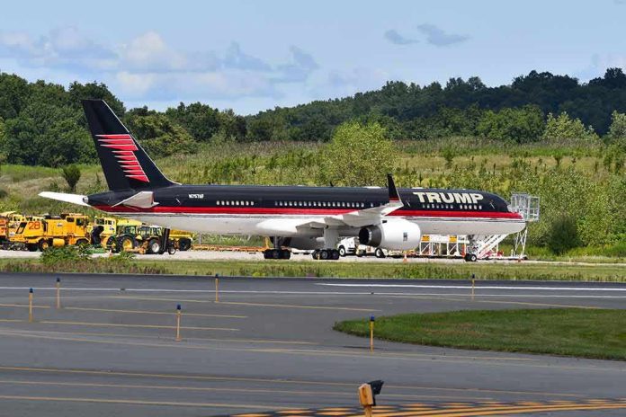 Private jet with black and red livery parked on airport tarmac