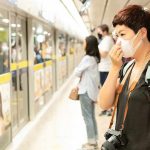 Chilling Metro Standoff Ignites RACIST Firestorm Woman wearing a face mask waiting on a subway platform