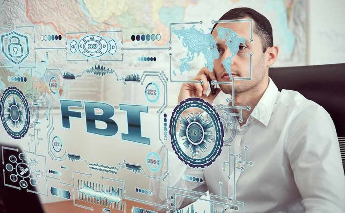 shutterstock_1650133459-1 Man on phone behind digital interface with FBI and cybersecurity graphics