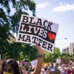 Activist BARRICADE City – Create BLM Only Zone protester holding a Black Lives Matter sign at a daytime march