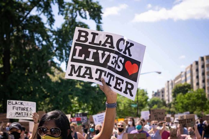 shutterstock_1752911258 protester holding a Black Lives Matter sign at a daytime march