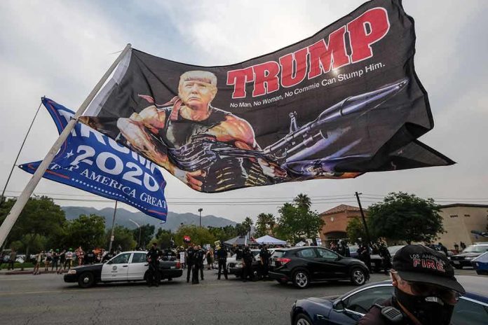 Large political flag over street protest with police and cars below