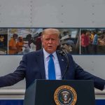 Navy U-Turn: Trump’s Name REPLACES Heroes Donald Trump speaks at a podium with arms outstretched