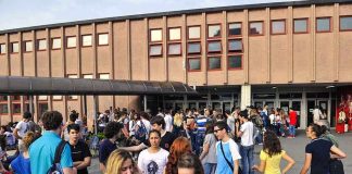 Students gathered outside a school building entrance