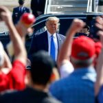 Trump’s Risky Joke Has Cabinet Floored Man in suit greeted by crowd with raised hands