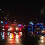 Super Drug Hits Streets – Teens Dead Nighttime police scene with flashing lights on a wet city street