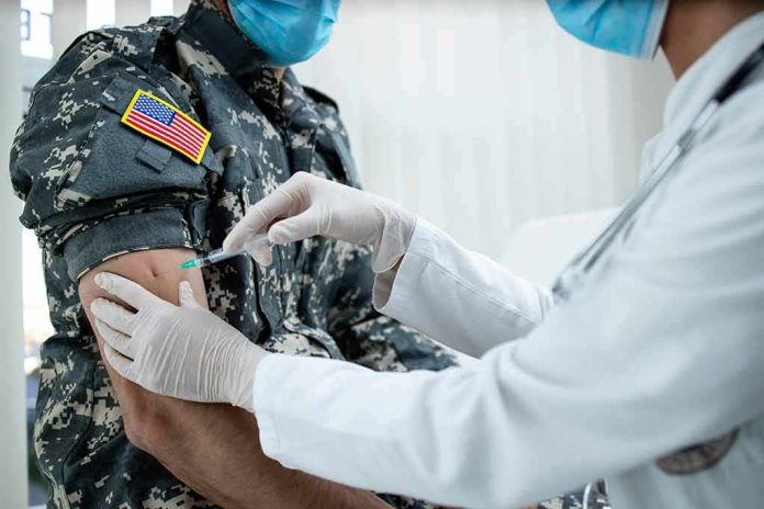 Healthcare worker giving vaccine to person in military uniform