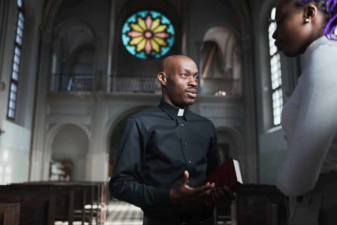 Priest speaking with a visitor inside a church