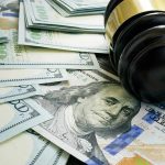 Judge's gavel on stacks of US hundred-dollar bills