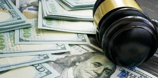 Judge's gavel on stacks of US hundred-dollar bills