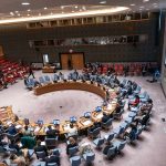 10 Rabbis TRAP Mamdani Behind Closed Doors Delegates seated around a circular conference table in a large chamber