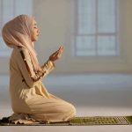 Taxpayer-Funded Ramadan Sparks Lawsuit – OUTRAGE! Woman in hijab praying on a mat indoors