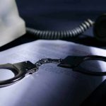 Murderous Teen’s Horrific ChatGPT Search Exposed Handcuffs on a document beside a coiled telephone handset