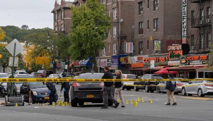 shutterstock_2214792793 Police investigate a taped-off urban street crime scene