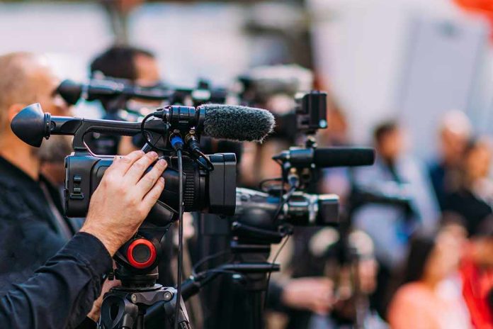 shutterstock_2233193507-4 Video cameras on tripods at a media event