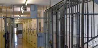 Prison corridor with barred doors