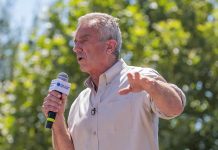 Man speaking into a microphone outdoors