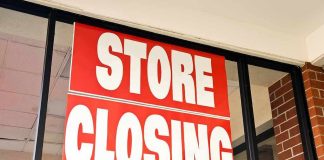 Storefront with red store closing sign