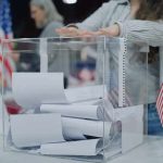 Red-State Stunned: Senate Race DEADLOCKED Person casting a ballot into a clear box at a polling station