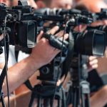 Dem Candidate Claims Jesus Was a Socialist television cameras on tripods at a media event