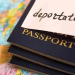 ‘Send Them Back’ Chants Erupt After New Migration Law PASSED! Stack of passports with a note labeled deportation on top, placed on a map