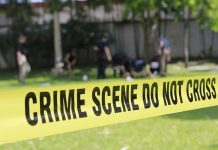 crime scene tape cordoning off a grassy area